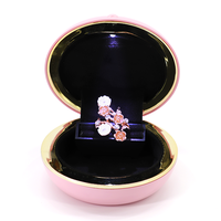 Boîte à bijoux de forme ronde, emballage de bijoux avec Logo personnalisé, boîte à bagues en plastique avec lumière Led