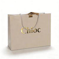 Sacs en papier kraft personnalisés pour le commerce de détail, sacs cadeaux pour vêtements, sacs d'emballage miniatures de luxe avec poignée, sacs en papier imprimés avec logos