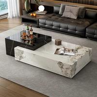 Table basse contemporaine noire et blanche rectangulaire avec plateau en pierre et rangement caché pour ensemble de canapés.