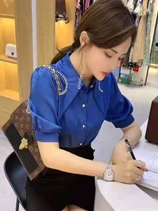 अनियमित गैंडे के साथ महिलाओं का रेट्रो ग्रीष्मकालीन ब्लाउज, सरल बटन सजावट के साथ एक आकार की मीठी शैली को चिकना करता है - Product Image 2