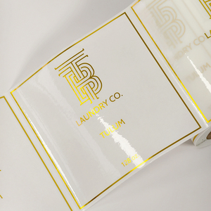 Premium <b>Transparent</b> Gold Foil Roll <b>Labels</b> Custom Clear Hot Stamping Stickers for Luxury Product Packaging - Product Image 1