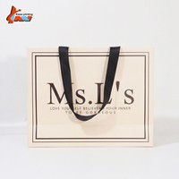 Sac de shopping en papier ivoire de luxe avec logo personnalisé, poignée en ruban noir, emballage cadeau pour boutique, vente en gros