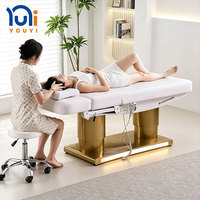 Lit de massage électrique à LED de conception nouvelle, 3/4 moteurs, base réglable à double cylindre dorée, pour clinique de soins de la peau