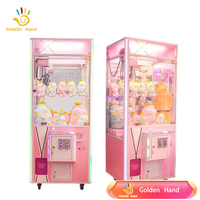 Machine à grue à monnayeur double fente en métal et plastique, 220V, dorée, avec interface multilingue (espagnol, japonais, anglais), personnalisable pour la distribution de poupées et jouets en peluche