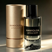 Flacon atomiseur de parfum cylindrique haut de gamme gris fumé à base épaisse, avec fond créatif en forme de montagne de glace et capuchon noir brillant, en verre personnalisé