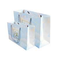 Sac de shopping en papier cartonné blanc de luxe réutilisable avec logo personnalisé, poignée en ruban et lamination