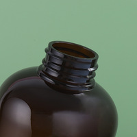 Flacon ovale Boston en plastique PET personnalisé Amber de 500 ml avec pompe noire pour cosmétiques, lotions, perruques, sérigraphie