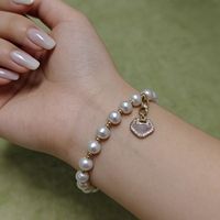 Bracelet en perles de riz d'eau douce avec fermoir Ruyi - Bijou porte-bonheur avec breloques CZ et coquillages pour femme