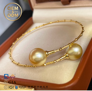 Pulsera de perlas doradas de lujo para mujer Perlas de Mar del Sur casi redondas de 10-12mm. Brazalete atemporal de diseño cruzado de plata 925 - Product Image 1