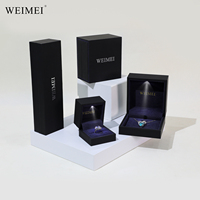 Caja de anillo LED de lujo con estampado de oro personalizado WEIMEI, paquete de manga ligera con papel especial de gamuza roja para diseño de cajón de joyería