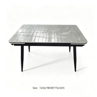 Table à manger de style minimaliste avec plateau en pierre frittée, fonction extensible, structure en métal noir pour salle à manger moderne