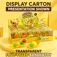 Vente en gros de jouets à presser en forme de banane géante transparente, remplis de fruits, avec boîte de vente au détail et présentoir en carton
