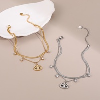 Bracelet superposé tendance pour femme en acier inoxydable doré, étanche, avec chaîne serpent, breloques œil de Dieu et signe du dollar