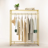Étagère de présentation de vêtements moderne sur mesure, neuve, en acier inoxydable, pour magasin de vêtements.