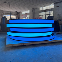 Comptoir de service LED en pierre translucide noire, moderne, rond, pour les zones de cinéma, les bars, les bureaux de réception