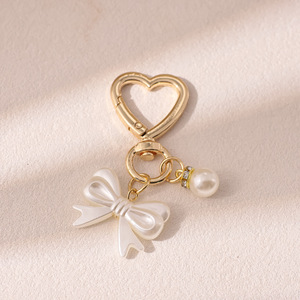 AM Fris en zoet strikje parel gouden deurknop sleutelhanger hanger schattig hoofdtelefoon etui tas hangend ornament - Product Image 6