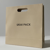Emballage de vêtements cosmétiques avec logo personnalisé sac de vêtement à poignée découpée sacs en papier en carton de luxe à provisions pour petites entreprises