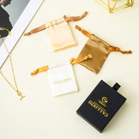 Boîte de rangement pour bijoux A1, collection sélectionnée, avec intérieur noir, logo doré et poignée frontale pour une présentation en boutique