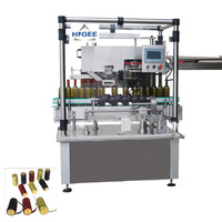 Machine de pose et de rétrécissement de capsules de vin en aluminium, machine de pose et de sertissage de capsules de bouteilles de vin en PVC et en aluminium multicouche