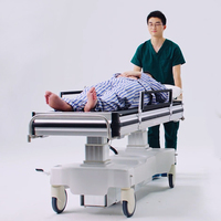 Lit d'hôpital électrique médical pour le transfert des patients avec moins de douleur et de travail par rapport aux draps de transfert ou aux planches de transfert des patients