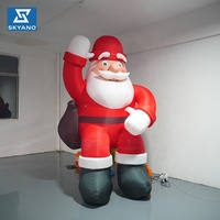 Père Noël gonflable géant personnalisé avec sac à dos pour la décoration de centres commerciaux en extérieur lors des événements de Noël