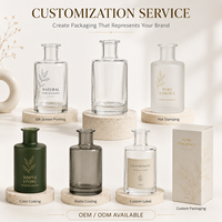 Flacon cylindrique élégant en verre transparent de 250 ml avec logo personnalisé et impression sérigraphique pour le stockage d'huiles essentielles et de parfums