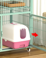 Cage à chat multi-niveaux en métal vert avec roulettes et espace de rangement, villa intérieure pour chats
