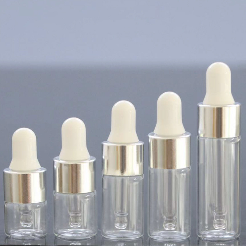 Tapa cuentagotas transparente + plateada + tetina blanca