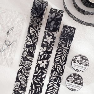 Un rotolo di nastro adesivo della serie Glimmers in The Dark, con supporto decorativo in sabbia glitterata bianco e nero per agenda. - Product Image 1