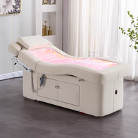 Table de massage électrique moderne personnalisée avec revêtement en cuir PU et fonction chauffante pour les soins de spa en hôtel