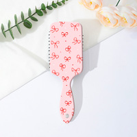 Brosse à cheveux démêlante portable style Coquette avec motif nœud léopard et coussin d'air, peigne de massage à palettes pour femmes