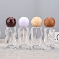 Bouteille de parfum vide en verre de 30ml en forme de vague au design unique, bouteille en verre rechargeable à brume fine pour huile essentielle cosmétique