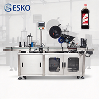 Applicateur d'étiquettes semi-automatique ESKO pour bouteilles rondes, idéal pour le shampoing, le savon, les masques capillaires, les sauces, les pots et les contenants en métal.