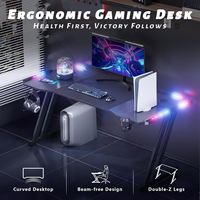 Escritorio Gamer Ergonómico RGB LED al por Mayor con Portavasos, Estructura Robusta en Forma de Z, Mesa de Computadora de Metal, Superficie de Fibra de Carbono, Estilo Moderno para Estudio