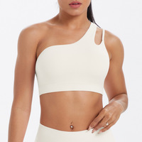 Sujetador deportivo asimétrico de un solo hombro para mujer al por mayor, con espalda recortada, transpirable, de Spandex/Nylon, soporte medio, a prueba de golpes, para correr y gimnasio.