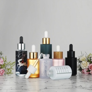 Botella de Vidrio con Gotero de 30 ml, Personalizada en Negro, Naranja y Azul, Multicolor, con Fondo Grueso y Tapa Serigrafiada para Uso Cosmético - Product Image 1