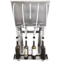 Machine de remplissage semi-automatique à 4 têtes par gravité pour l'emballage des boissons gazeuses, du vin rouge et du vin de fruits