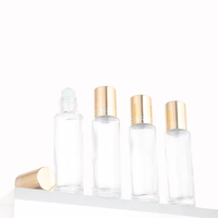 Flacon à rouleau en verre transparent de 15ml avec couvercle en or et rouleau en acier pour bouteille en verre à bille de parfum d'huile essentielle