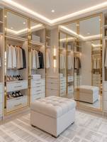 Dressing moderne de luxe avec portes vitrées à cadre doré, éclairage LED, étagères réglables, tiroirs et système de rangement personnalisé