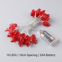Guirlande lumineuse LED blanc chaud avec ornement nœud rouge, câble transparent, fonctionnant sur piles, pour décoration de Noël