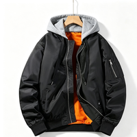 Blouson bomber décontracté noir pour homme avec capuche tricotée amovible, patchwork, doublure intérieure orange écologique, poignets côtelés et poches zippées