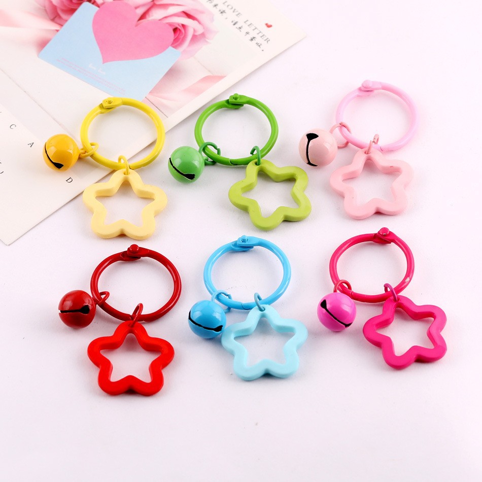 Book ring with real colored five-pointed star and bell