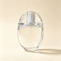 Flacon de parfum unique en forme d'œuf transparent de 100 ml, flacon pulvérisateur portable, flacon cosmétique de voyage avec boîte d'emballage