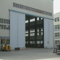 Porte coulissante électrique industrielle avec commande manuelle, panneau sandwich en mousse PU pour entrepôt et atelier