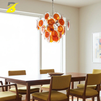 Lustre vintage en verre orange avec couches extérieures transparentes et cadre chromé pour salle à manger et salon rétro, style mid-century