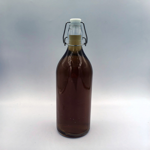 Bouteille en verre transparente ronde de 1000 ml (535 g) avec bouchon à bascule en métal, prix usine, fournisseur direct, <span class=keywords><strong>moins</strong></span> <span class=keywords><strong>cher</strong></span> - Product Image 1