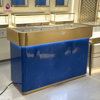 Vitrine de luxe Sundo pour bijoux, présentoir bleu rétroéclairé, niche murale dorée, fabricant d'agencements de magasin