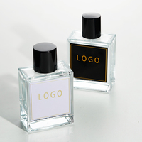 Flacon de liquide de parfum d'aromathérapie en verre de luxe vide et transparent de 50ml avec bouchon noir et logo personnalisé