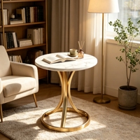 Table d'appoint moderne et durable avec plateau en pierre rond et structure en métal pour le coin du canapé du salon