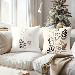 Elegantes cojines decorativos botánicos que adornan un sofá acogedor con calcetines navideños festivos y astas de reno en el fondo. - Product Image 4